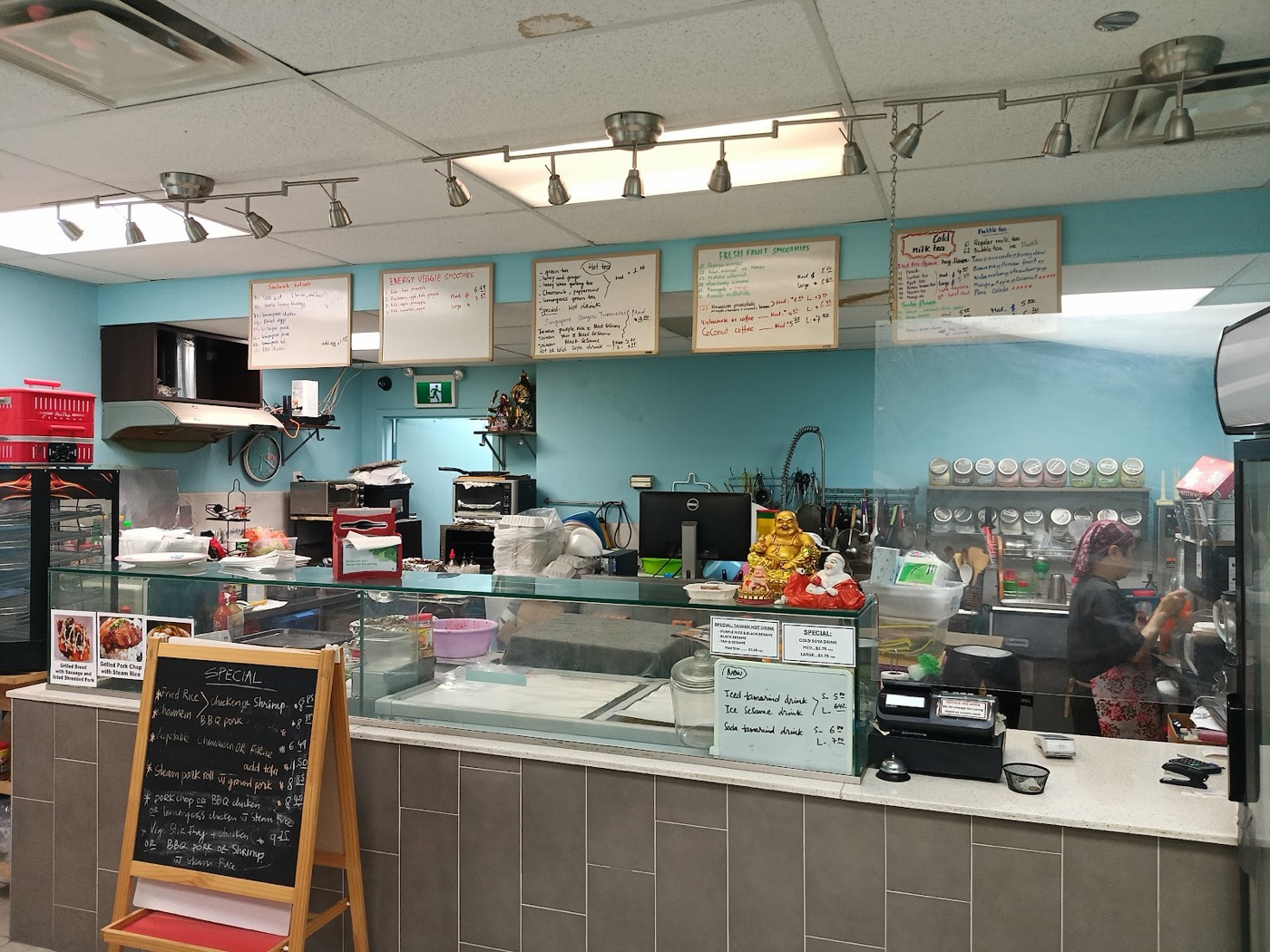 Inside the 88 Foods takeaway counter with menu boards
